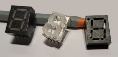 A LED display digit, a 7-segment lead frame, and a display housing